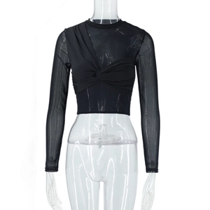 Detail of sheer mesh sleeves and front twist knot on this black cropped top for women