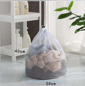 Close-up of a white mesh laundry bag with drawstring measuring 40x50cm in a bathroom