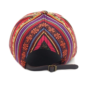 Detail of bohemian baseball cap featuring ethnic embroidery and leather strap closure