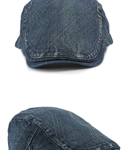 Close-up of the washed denim flat cap showing detailed stitching and fabric texture