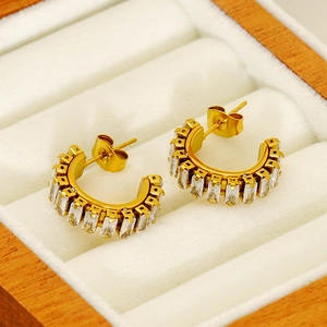 French vintage gold C-shape earrings with baguette-cut zircon in a white jewelry box