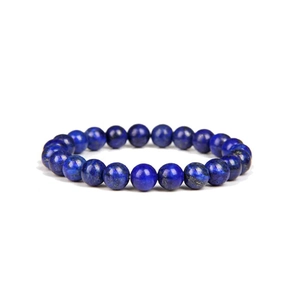 Macro view of blue lapis lazuli natural stone beads on a single strand bracelet