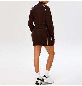 Detail view of brown long-sleeve zip jacket and matching skirt with white side stripes