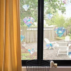 Detailed view of diamond-shaped rainbow prism window films creating a colorful light effect
