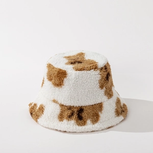 Close-up of soft white sherpa fleece bucket hat with cute brown bear pattern details