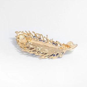 Vintage golden peacock feather brooch with blue enamel inlay and a white pearl accent