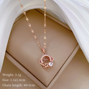 Macro shot of rose gold bear crown pendant with 520 engraving and zircon stone in jewelry box