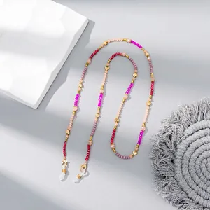 Detail of colorful crystal beaded eyeglass chain with golden heart charm and lobster clasps