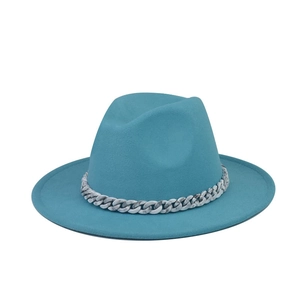 Close-up of a teal woolen fedora hat featuring a stylish marble-patterned chain.