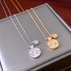 Macro detail of gold and silver starburst necklaces with zircons on a jewelry box