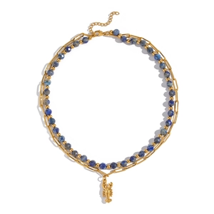 Detail of double-layer necklace featuring gold paperclip chain and blue gemstone beads