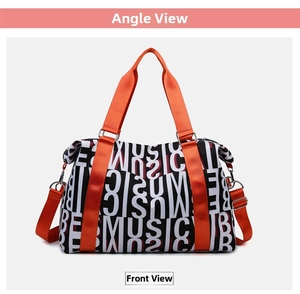 Detail view of large capacity duffel bag with bold music pattern and orange straps