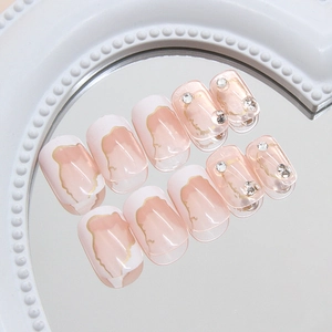 Elegant square-oval press-on nails with nude pink base, white French tips, and gold leaf foil