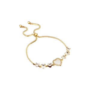 Gold plated heart bracelet with mother of pearl and zircon stones on a white background