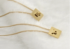 Close-up of 18K gold-plated stainless steel square pendants with zodiac symbols