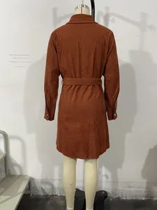 Back view of brown corduroy shirt dress with waist tie on a mannequin in a studio
