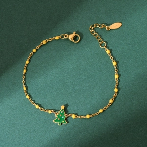 Close-up of a gold stainless steel beaded bracelet with a green enamel Christmas tree charm