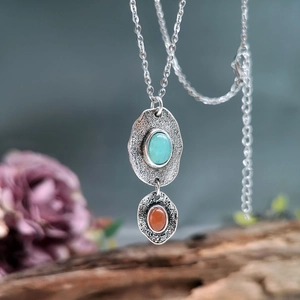 Bohemian silver necklace featuring turquoise and orange gems with hammered texture metal