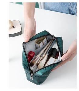 Interior view showing the large capacity of a dark green quilted cosmetic bag