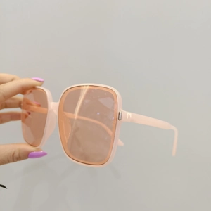 Detailed view of light pink oversized square sunglasses with translucent resin frames