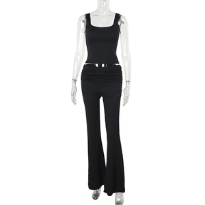 Detail of black two-piece set featuring a U-neck slim vest and flared pants texture