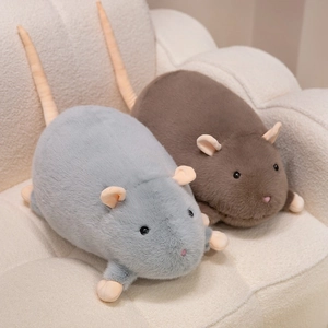Cute plush mouse dolls in grey and brown colors lying on a sofa for home decor