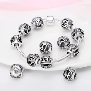 Silver zodiac charm bracelet with snake chain and crystal-studded constellation beads