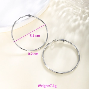 Detail view of silver chain-pattern hoop earrings with 5.1cm diameter measurement