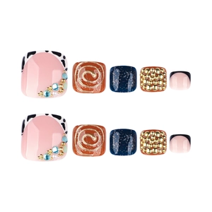 3D press-on toe nails with golden rhinestones and cow print designs in vibrant colors