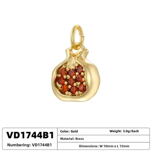 Macro view of gold brass pomegranate pendant with red crystals and dimensions 10x15mm