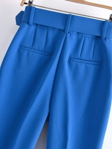 Detalle de los pantalones azules de cintura alta con trabillas y bolsillos falsos