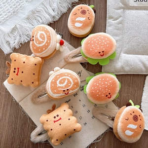 Close-up of plush burger and bread hair clips with cute embroidered smiley faces
