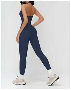 Detail of cross-back halter neck on dark blue yoga jumpsuit with matte texture fabric
