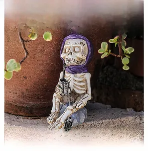 Detailed macro view of resin skeleton fisherman statue with purple bandana in garden