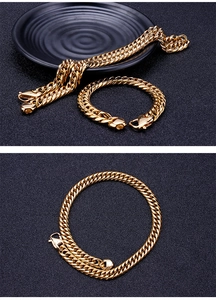 Close-up of a polished gold-plated stainless steel Cuban link chain on a black background