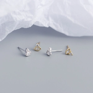 Close-up of gold and silver S925 sterling silver stud earrings with marquise zircon