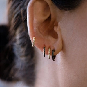 Close-up of S925 sterling silver hoop earrings with micro-pave crystals on model ear