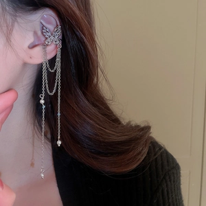Detail of silver butterfly ear cuff with sparkling zircon tassels and pearl accents