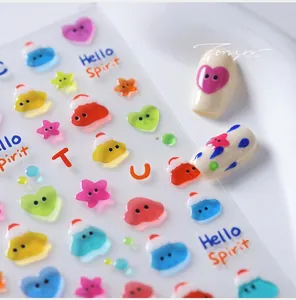 Macro shot of 3D embossed Christmas nail stickers featuring cute colorful cartoon motifs