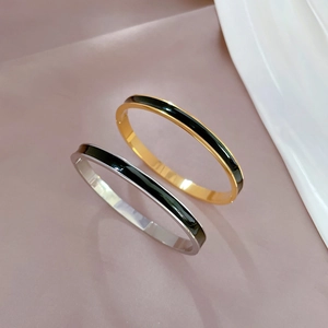 Minimalist gold and silver titanium steel bangles with black enamel inlay design