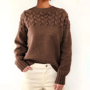 Close-up of brown cable knit texture on a long-sleeved thick turtleneck sweater