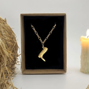 Retro gold cowboy boot pendant necklace on Figaro chain inside a rustic gift box