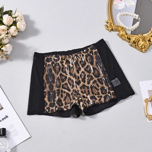 Detail of leopard print sequin shorts with sheer mesh stitching and fashionable accessories
