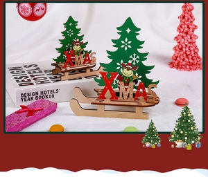 Detail of DIY wooden Christmas sleigh ornament with Xmas letters and deer on white fur