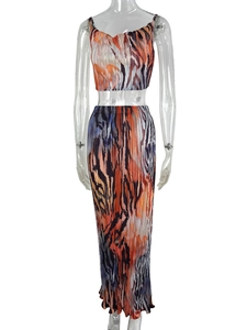 Detailed view of the pleated fabric texture and abstract print on women's two-piece set
