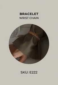 Macro view of a chunky gold watch-band style titanium bracelet on a dark shirt cuff