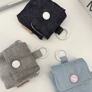 Detailed texture of denim earphone pouch with metal snap and hanging hook in three colors