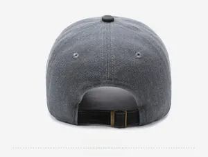 Detail of adjustable metal buckle and black strap on grey vintage baseball cap