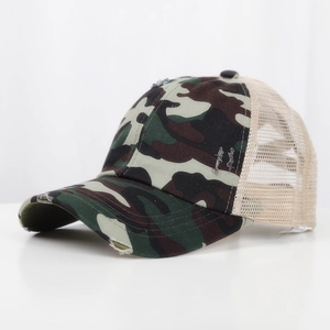 Close-up of camo baseball cap featuring distressed torn brim and beige breathable mesh