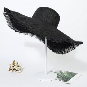 Women's summer black woven straw beach hat with wide frayed brim and fringe detail